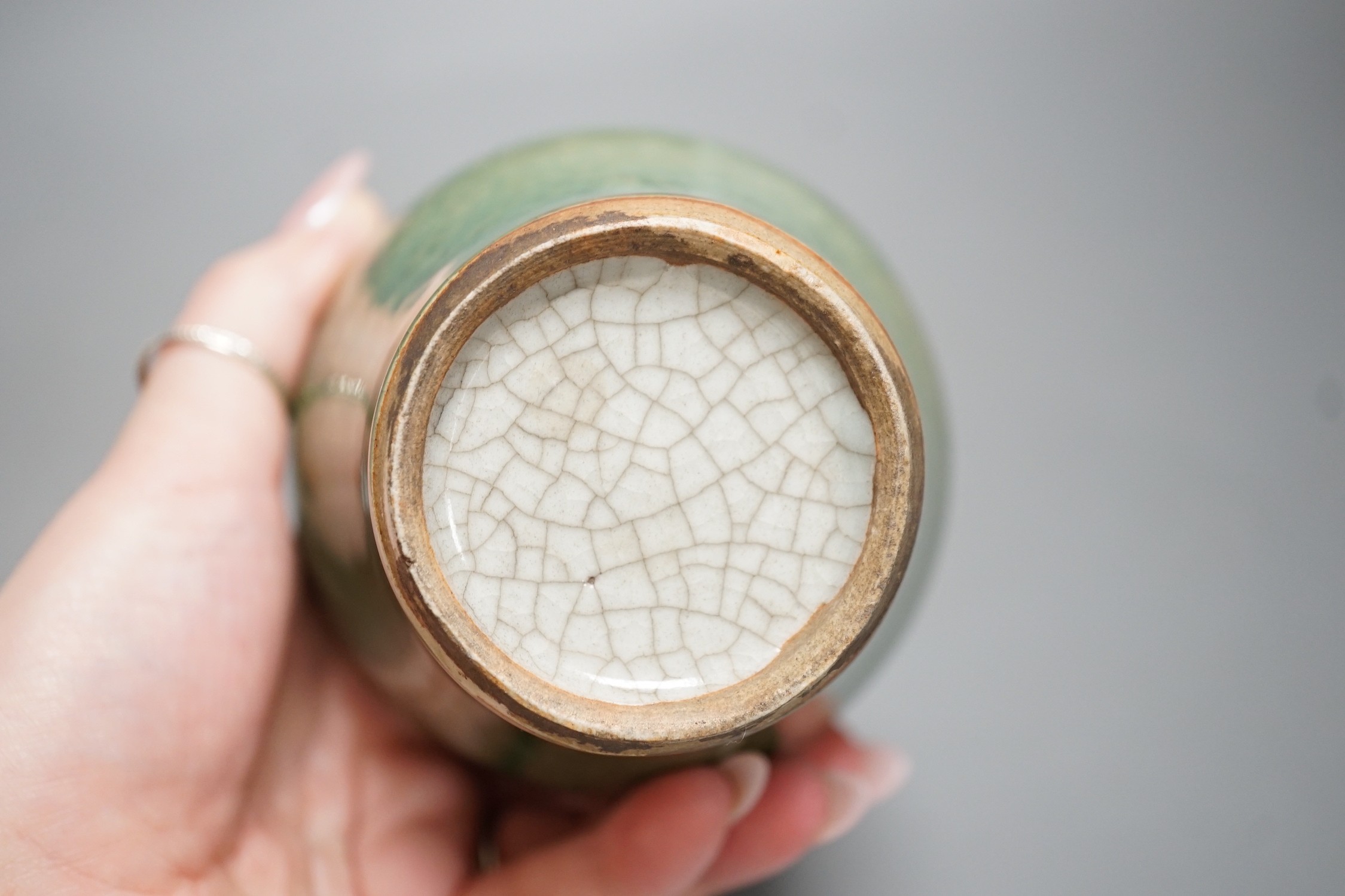 A Chinese white crackleware vase and a smaller green glazed vase